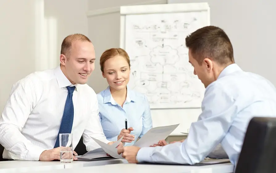 A woman leading two men in a meeting